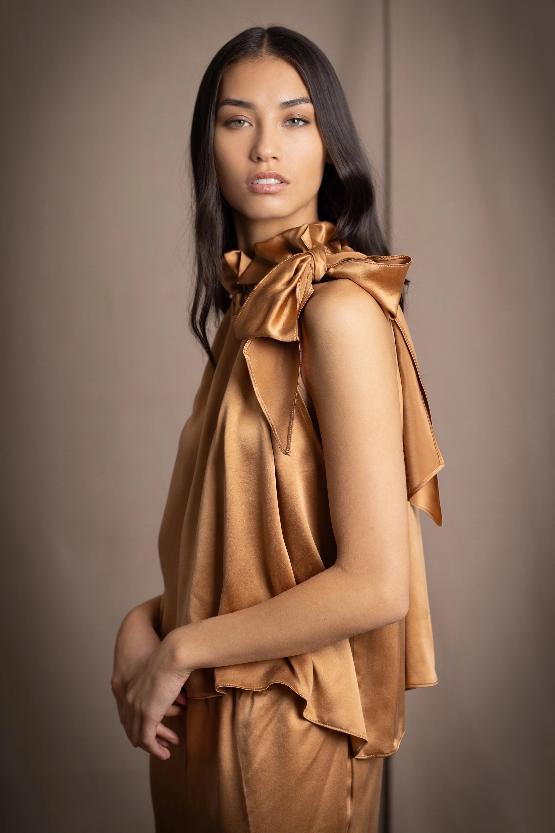 a woman wearing silk velvet top in green