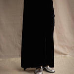 a woman wears a silk velvet skirt in black