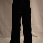 a woman wears silk velvet trousers in black with elasticated waist