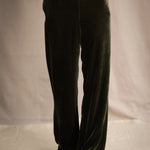 a woman wears silk velvet trousers in olive green with elastic waist