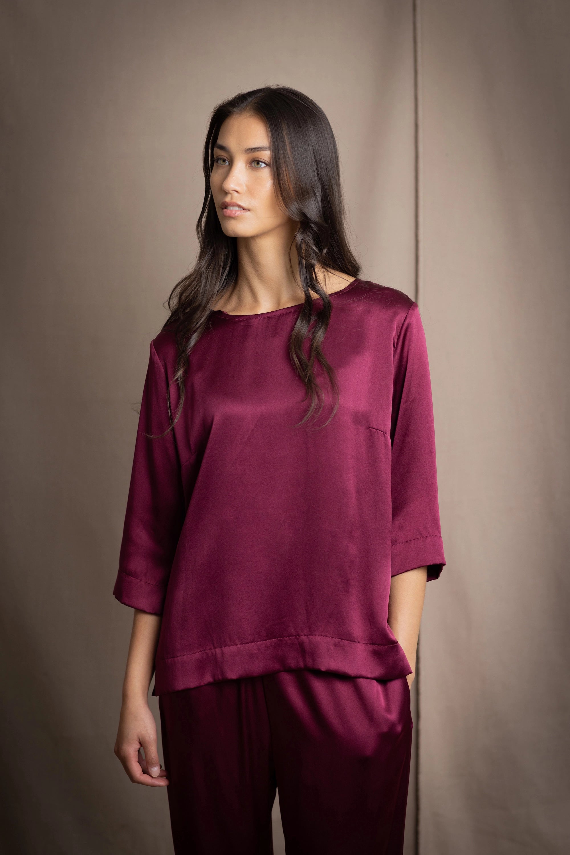 a 3/4 sleeve silk blouse in burgundy with matching trousers