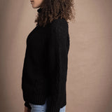 Woman wears traditional Irish Cashmere Aran Sweater in Black