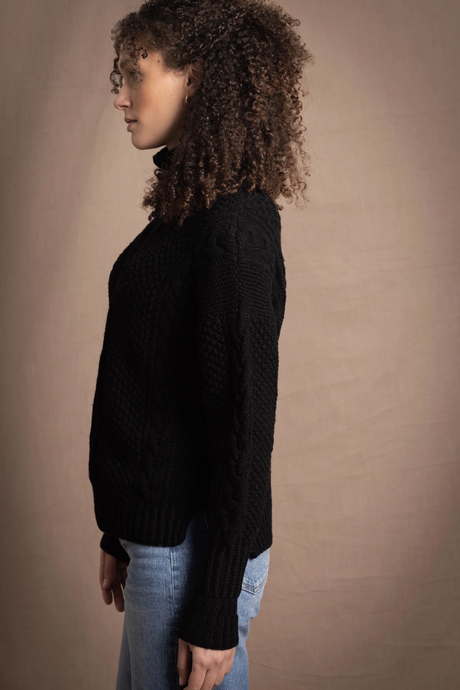 Woman wears traditional Irish Cashmere Aran Sweater in Black