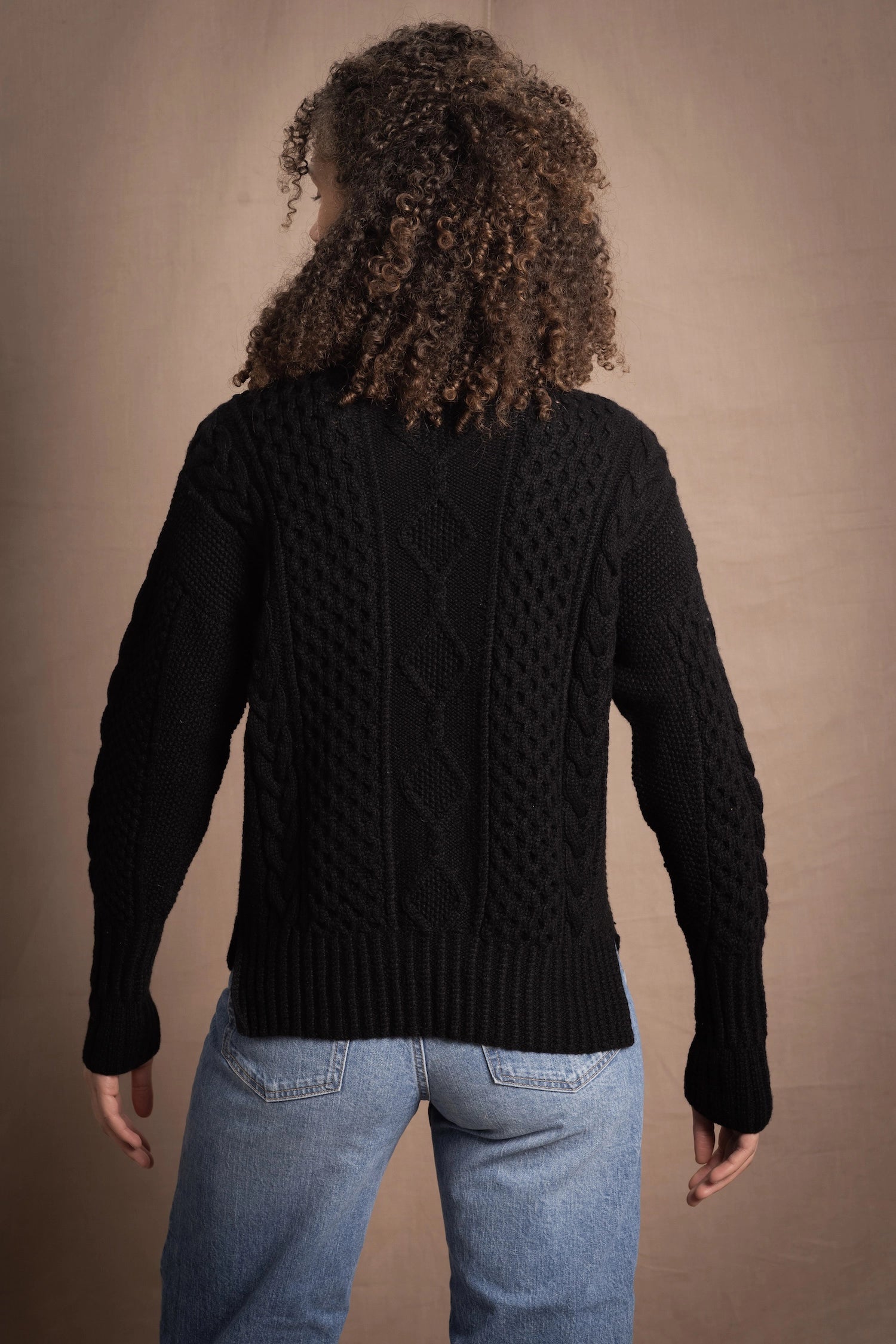 Woman wears traditional Irish Cashmere Aran Sweater in Black