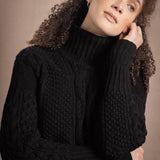 Woman wears traditional Irish Cashmere Aran Sweater in Black