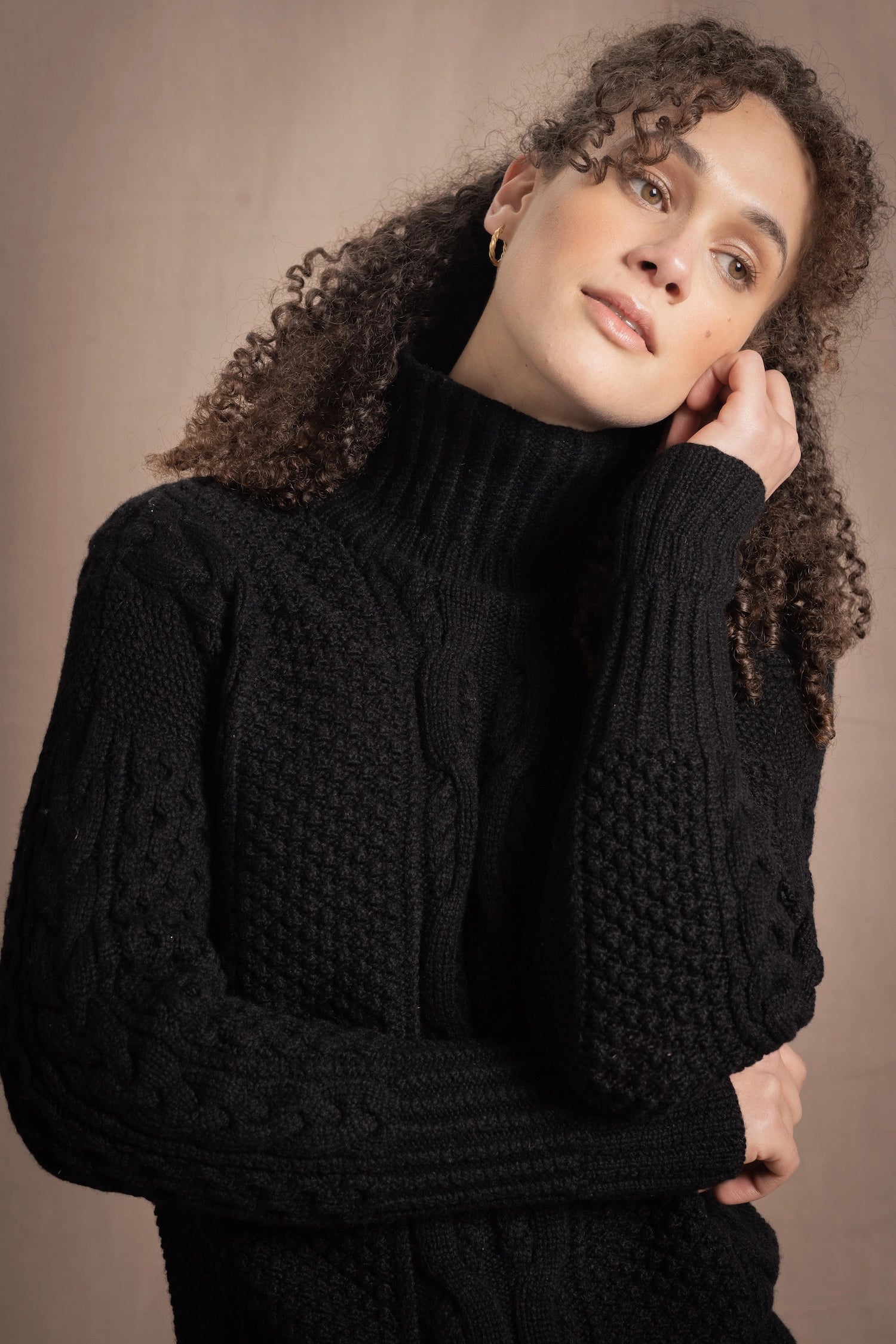 Woman wears traditional Irish Cashmere Aran Sweater in Black
