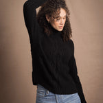 Woman wears traditional Irish Cashmere Aran Sweater in Black