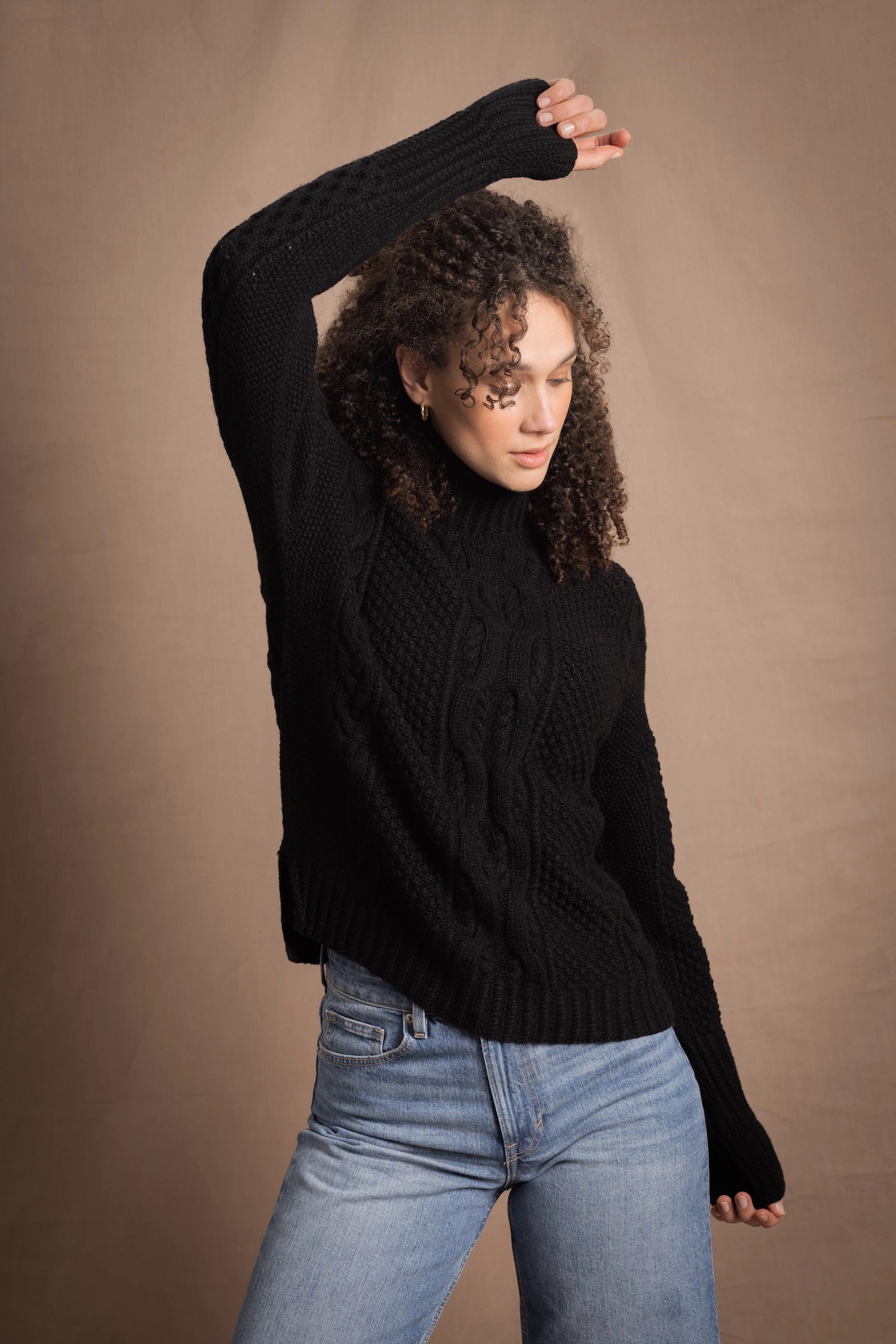 Woman wears traditional Irish Cashmere Aran Sweater in Black