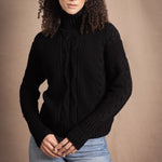 Woman wears traditional Irish Cashmere Aran Sweater in Black