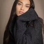 woman wearing an oversized cashmere sweater with cowl neck in black with silver metallic lurex thread