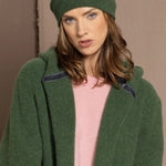 woman wearing a green cashmere beanie hat