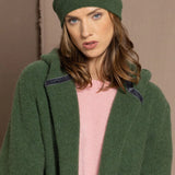 woman wearing a green cashmere beanie hat