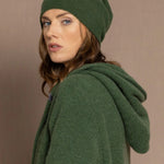 woman wearing a green cashmere beanie hat