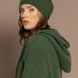 woman wearing a green cashmere beanie hat