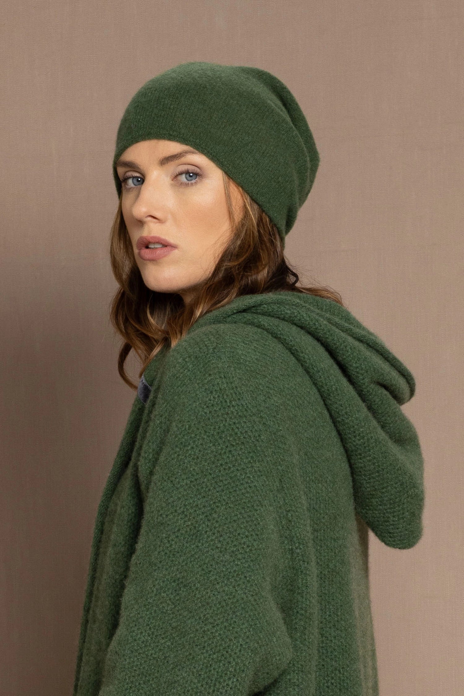 woman wearing a green cashmere beanie hat