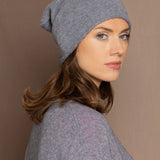 a woman wearing a cashmere beanie hat in grey