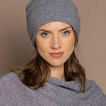 a woman wearing a cashmere beanie hat in grey