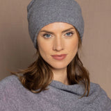 a woman wearing a cashmere beanie hat in grey