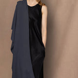 Woman wearing a navy blue cashmere wrap shawl over a black silk dress