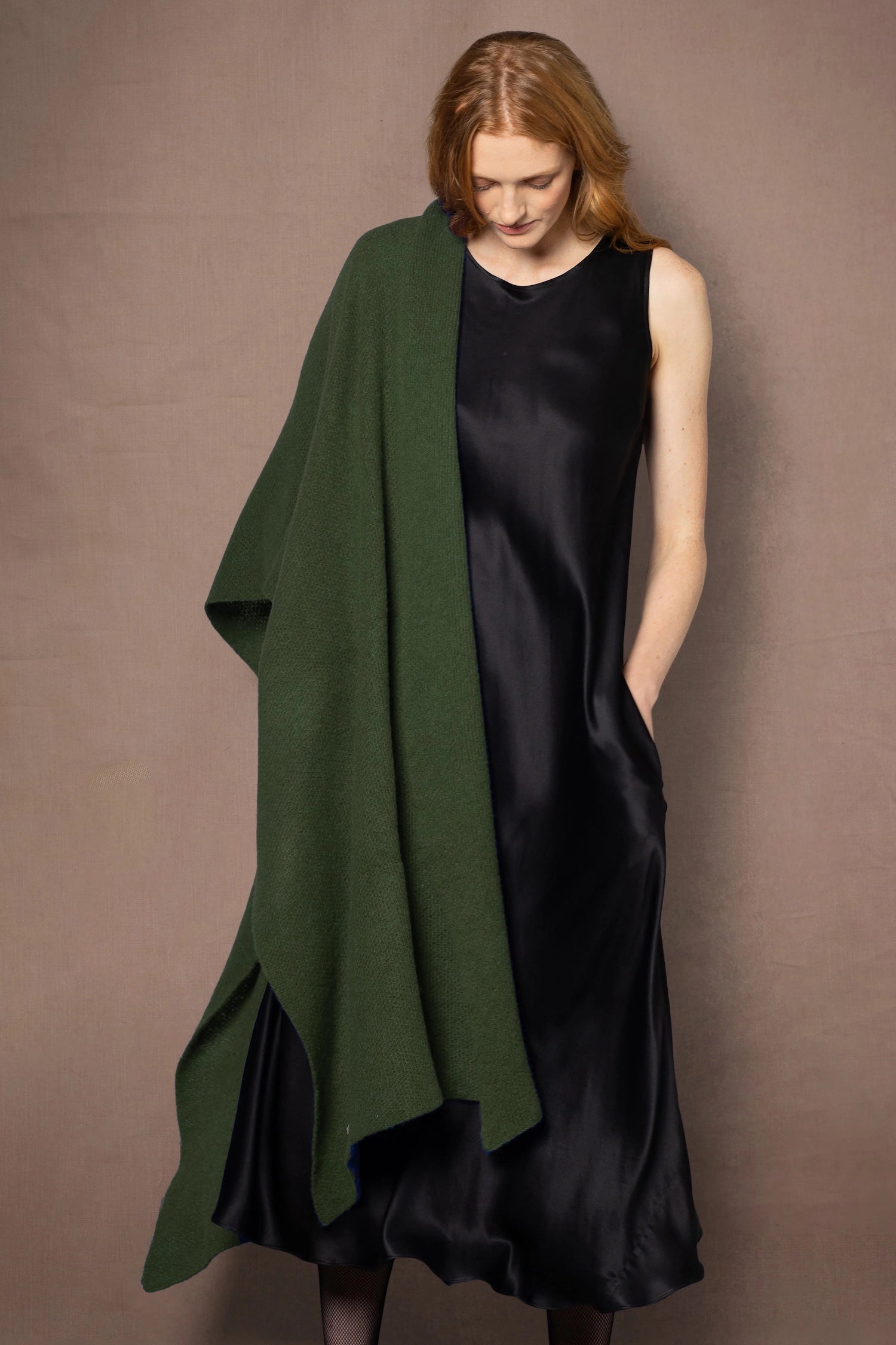 woman wearing a black dress with a large green cashmere wrap