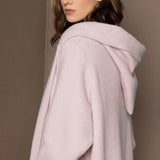 woman wearing a long cashmere hooded coat cardigan in pale pink
