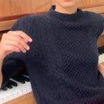 video of a woman wearing a cashmere aran sweater tee in navy blue with orange silk skirt