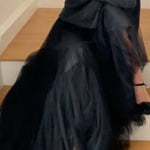 video of a woman wearing a cropped cashmere oversized cashmere sweater in black with metallic silver lurex thread and tulle skirt in black