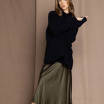 green silk skirt and black sweater