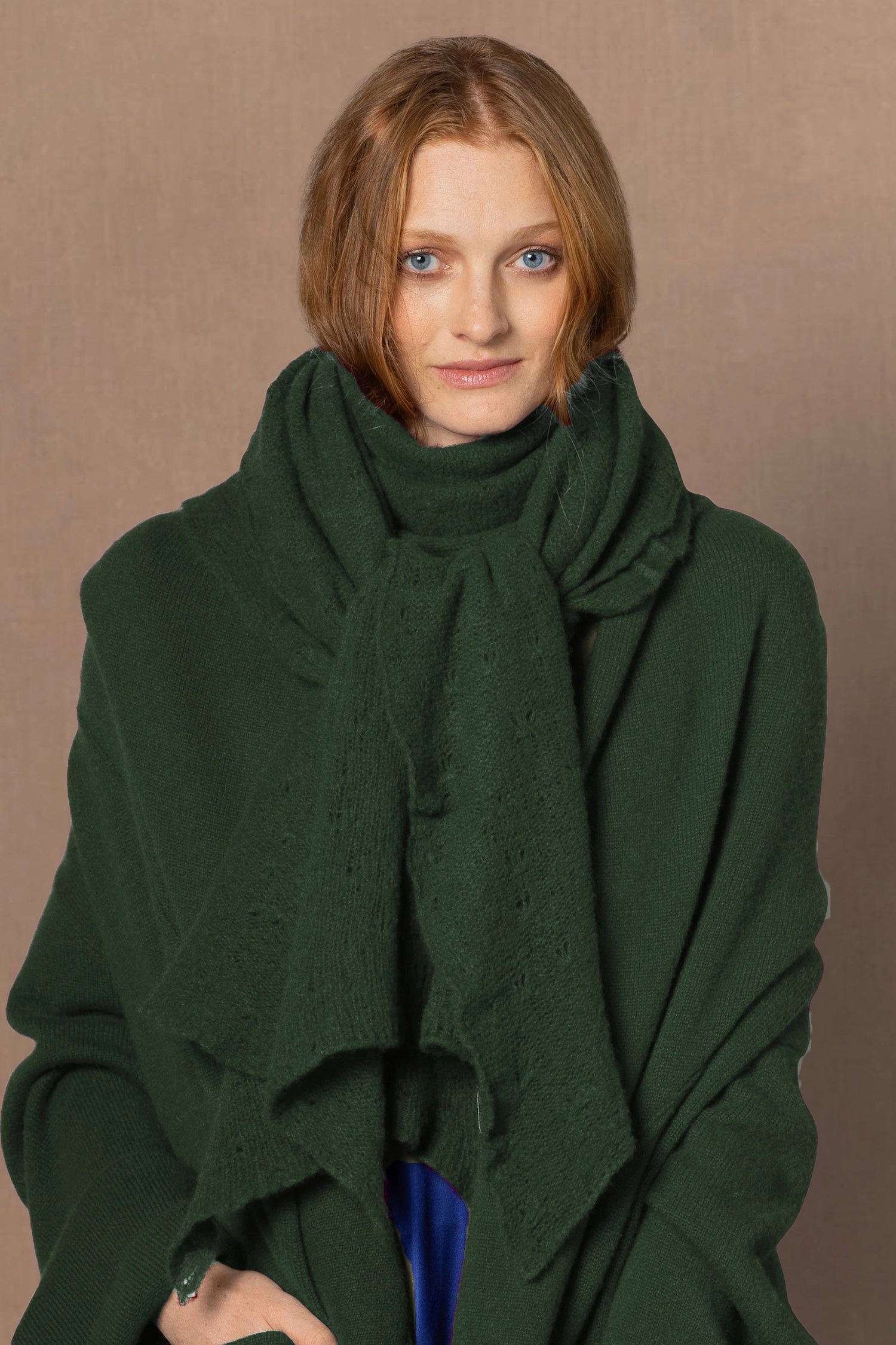 woman wearing a dark green cashmere scarf wrap with matching cardigan coat