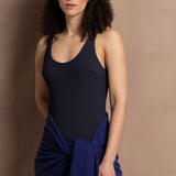 A woman wears a bright blue cashmere shawl wrapped around her