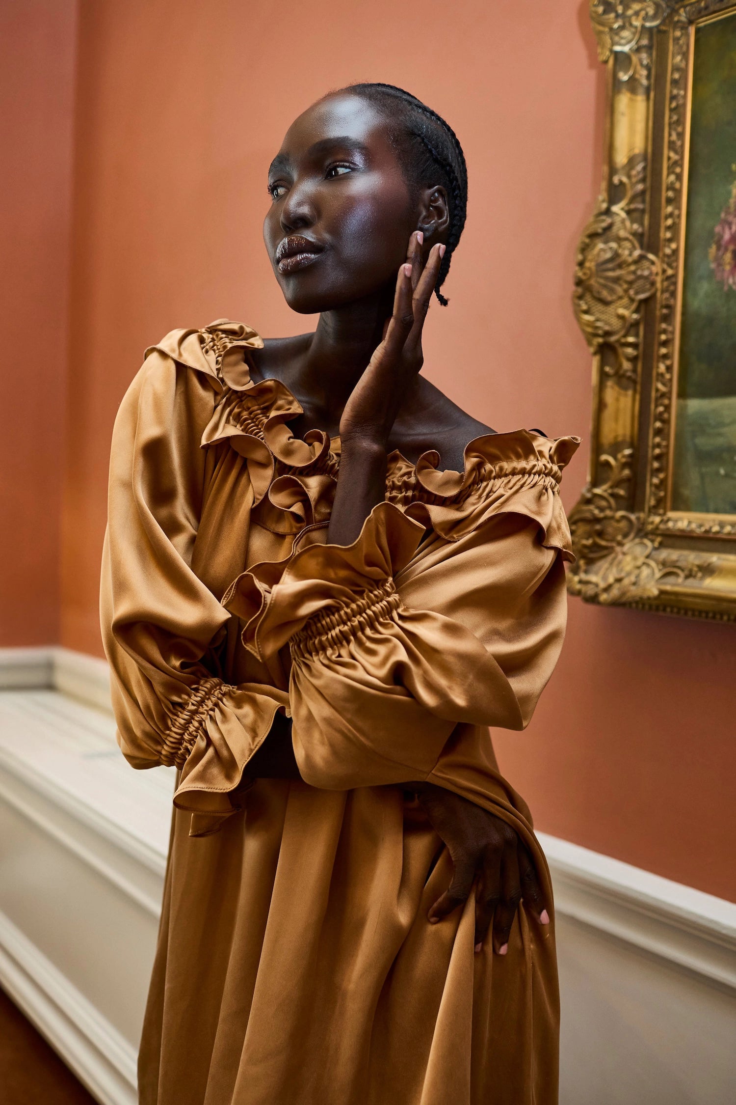 Woman in a bronze silk dress posing 