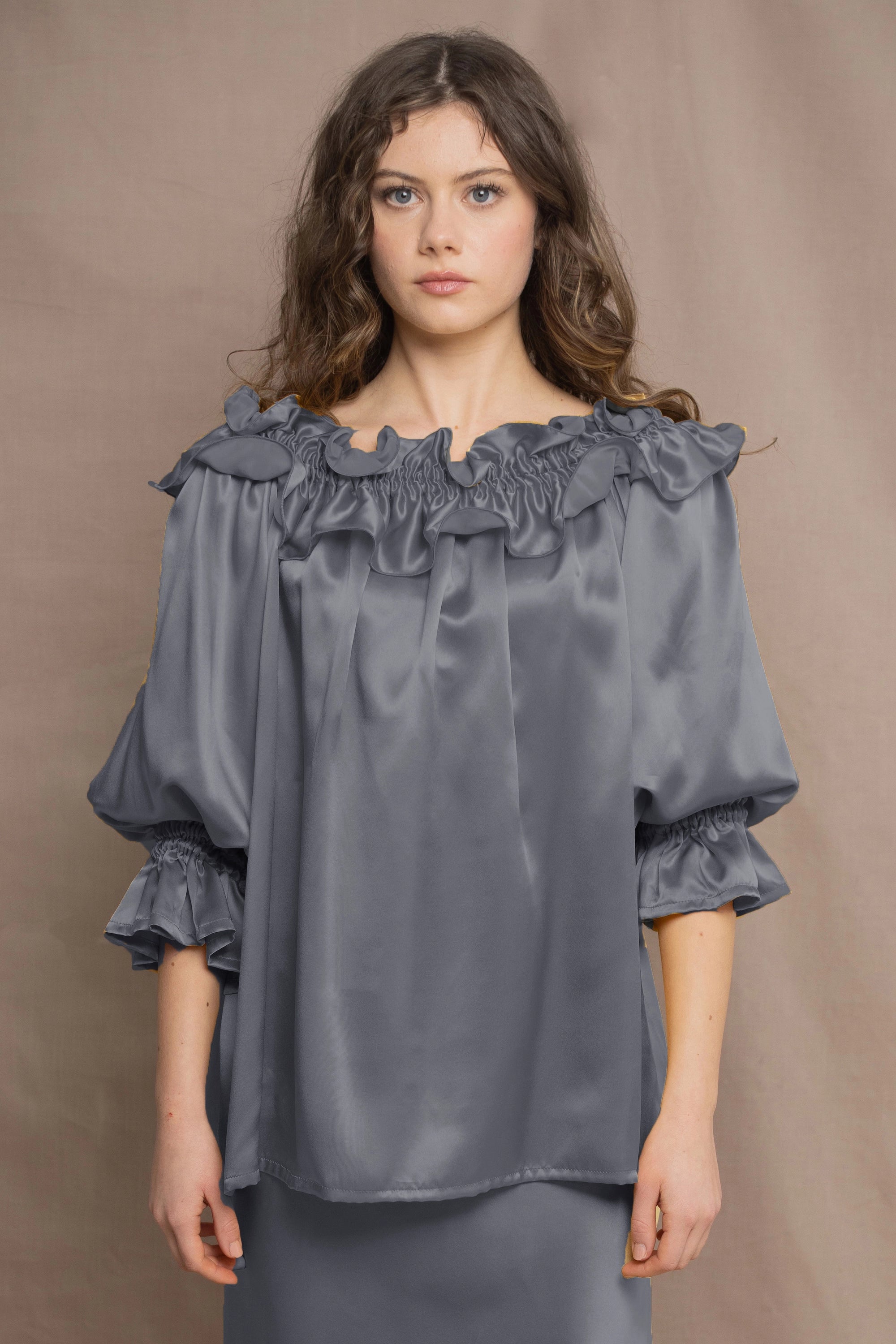 a woman wears a pewter grey silk top 