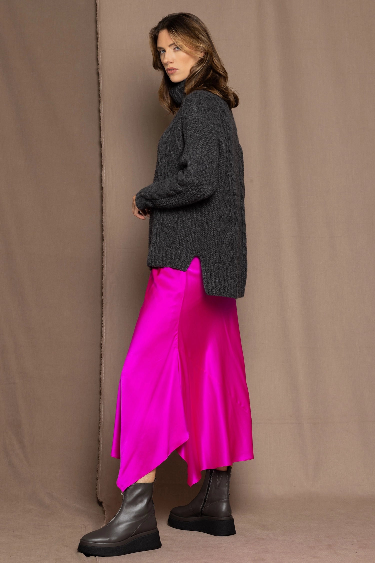 Cashmere Aran Sweater in Grey with a bright pink silk skirt