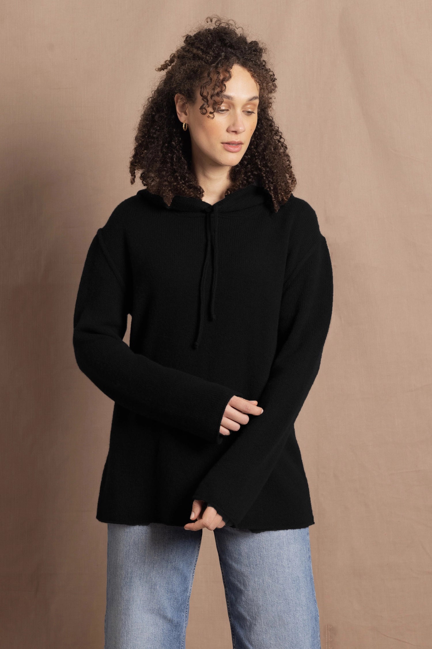 lady wears cashmere hooded sweater in black