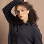 close up shot of lady wearsing and oversized pure cashmere hoodie sweater in grey blue colour