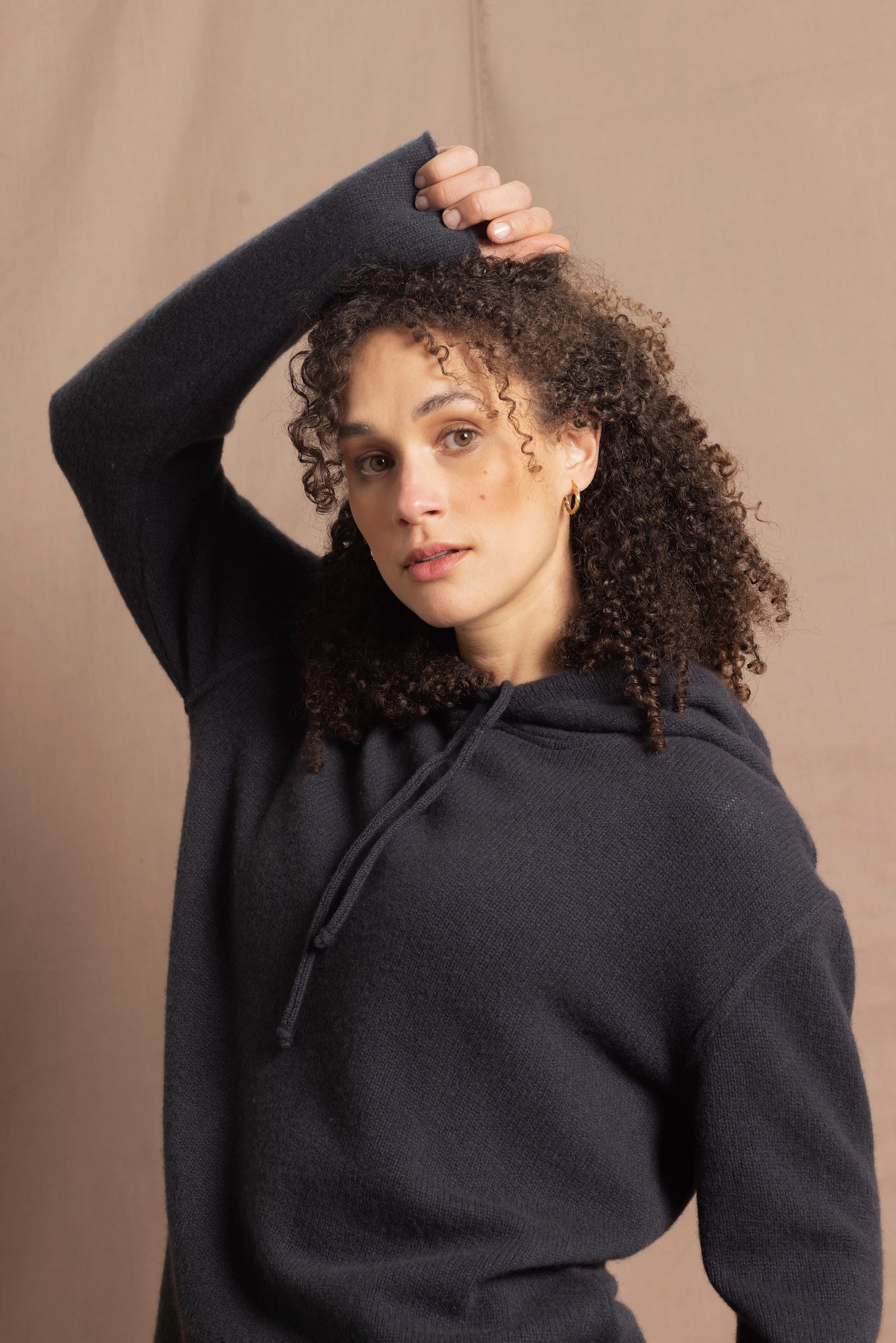 close up shot of lady wearsing and oversized pure cashmere hoodie sweater in grey blue colour