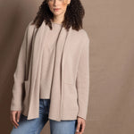 Lady wears beige coloured open cashmere cardigan over matching cashmere tee 