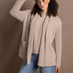 Lady wears beige coloured open cashmere cardigan over matching cashmere tee 