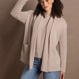 Lady wears beige coloured open cashmere cardigan over matching cashmere tee 