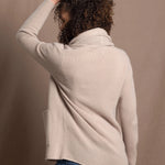 Lady wears beige coloured open cashmere cardigan over matching cashmere tee 