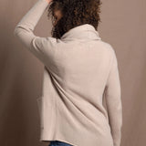 Lady wears beige coloured open cashmere cardigan over matching cashmere tee 