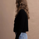 a woman wears a pure, 100% cashmere button down cardigan in black