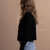 a woman wears a pure, 100% cashmere button down cardigan in black