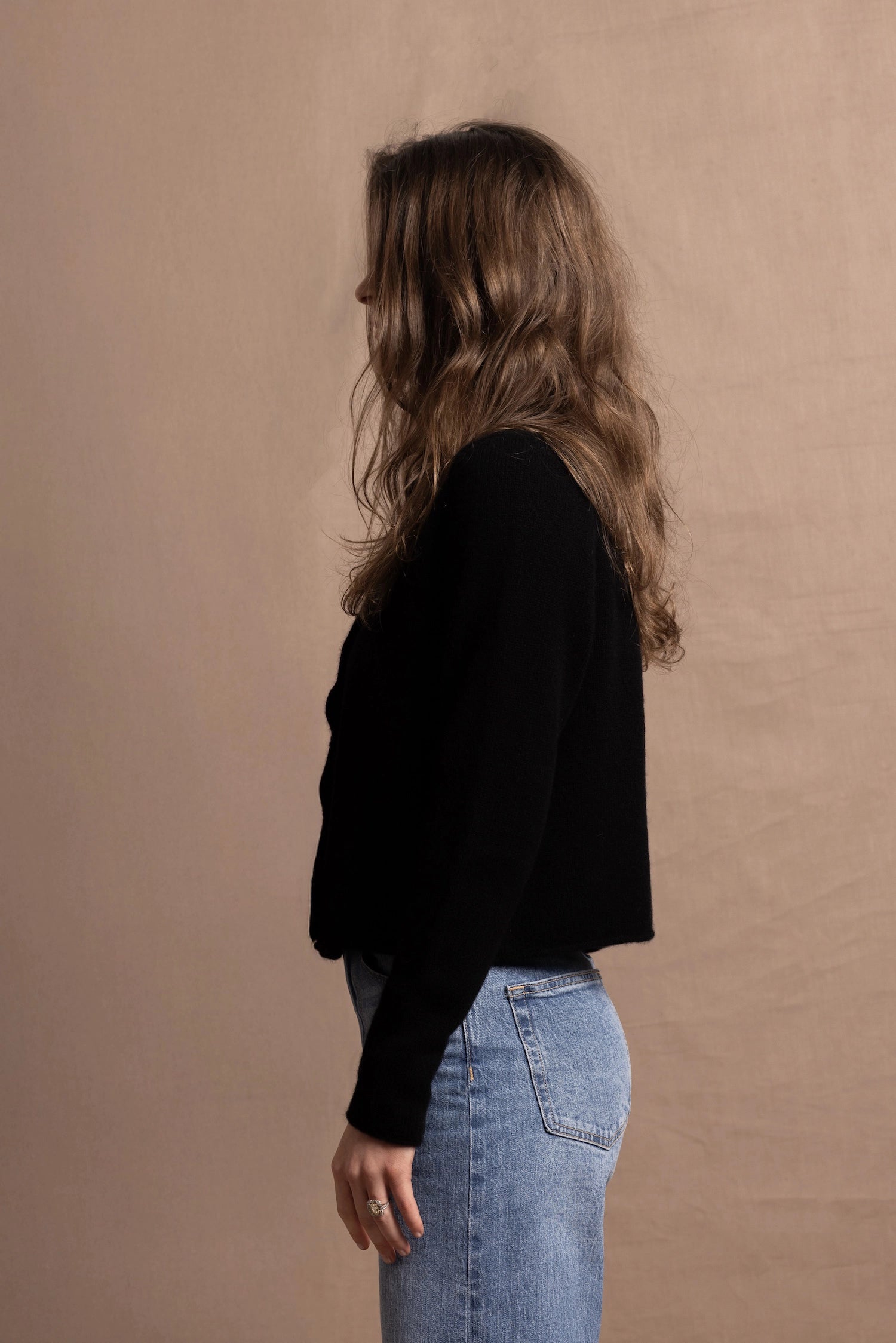 a woman wears a pure, 100% cashmere button down cardigan in black