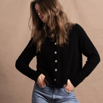 a woman wears a pure, 100% cashmere button down cardigan in black