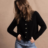 a woman wears a pure, 100% cashmere button down cardigan in black
