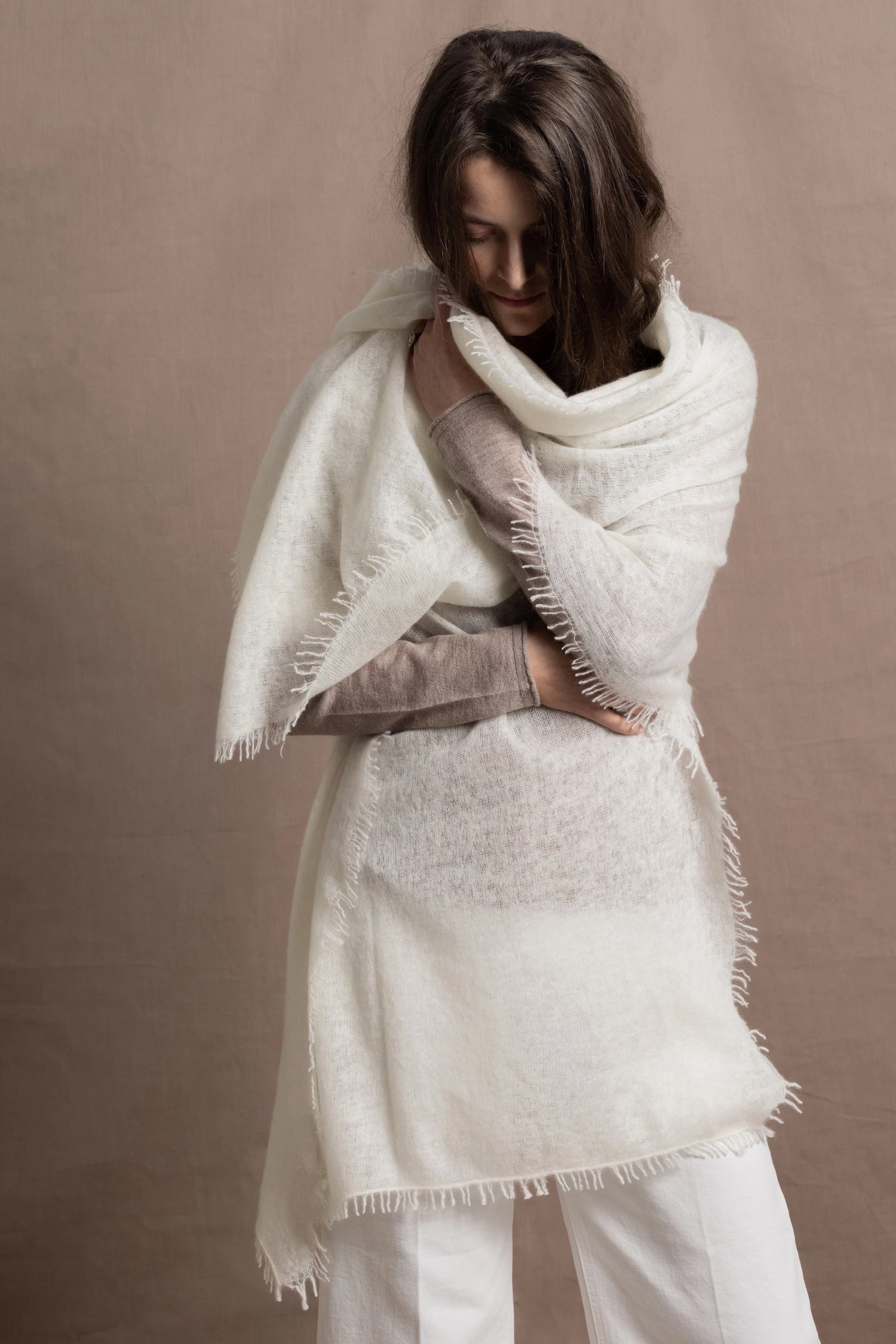a woman wears a pure 100% cashmere wrap scarf or shawl