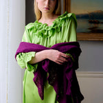 Woman in a purple 100% cashmere scarf wrap shawl and lime green silk ruffle dress