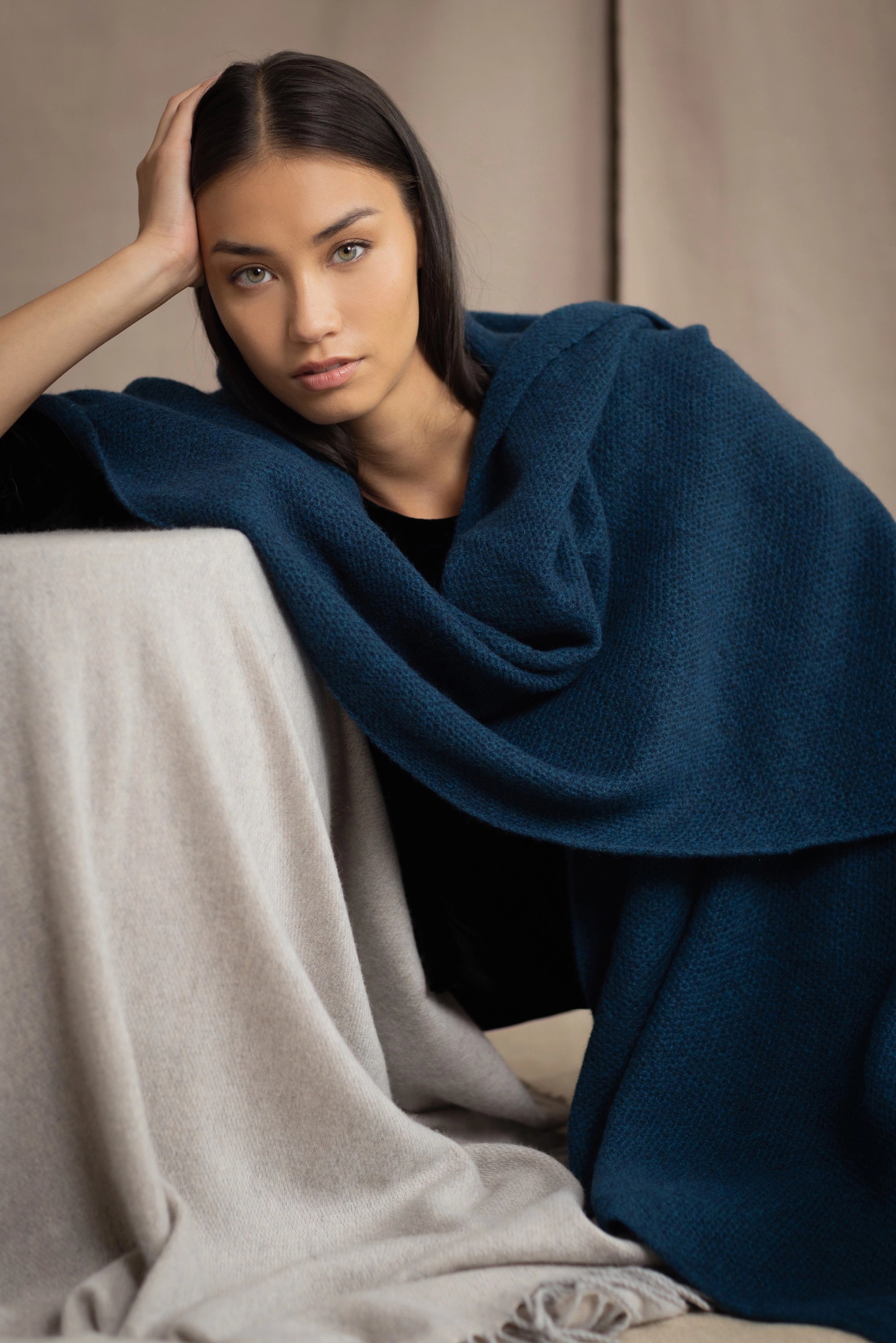 woman wearing large cashmere scarf in teal