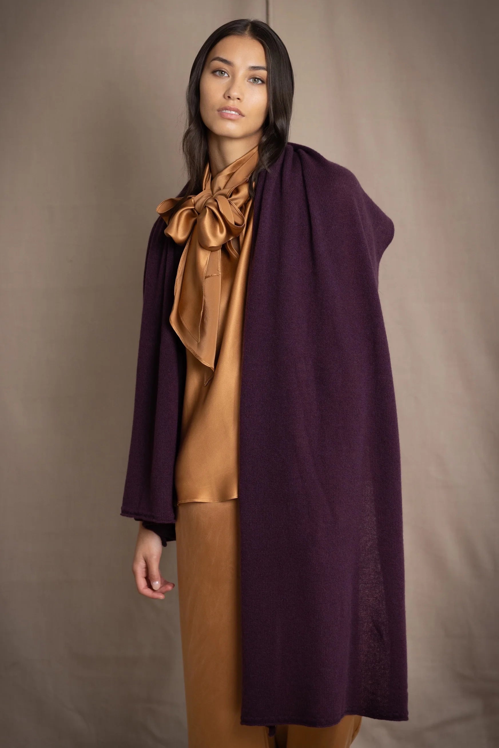 Woman wearing a large cashmere wrap scarf shawl in dark purple